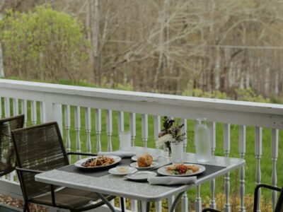 a couple of chairs sitting on top of a wooden deck
