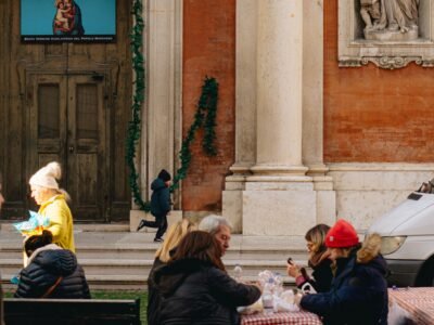 a group of people sitting at a table in front of a building